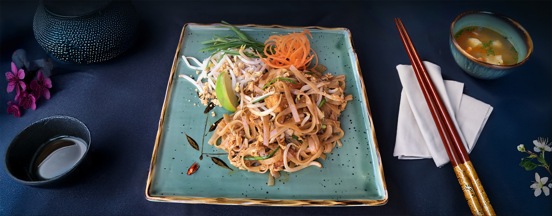 Pan thai noodle dish on a decorated table